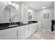 Bright bathroom featuring dual sinks, black granite countertops, and updated fixtures, providing modern convenience at 105 Corral Cir, Summerville, SC 29485