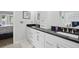 Elegant bathroom with dual vanities, black countertops, and modern design, offering a luxurious experience at 105 Corral Cir, Summerville, SC 29485