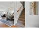 Carpeted staircase with white banister leading to the upper level, complemented by elegant dining area at 105 Corral Cir, Summerville, SC 29485