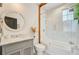 Stylish bathroom featuring a modern vanity, a large mirror, and a glass-enclosed shower/tub combo at 11 Francis St, Charleston, SC 29403