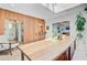 Bright dining room showcasing wood floors, wood accent wall, and an adjacent bath at 11 Francis St, Charleston, SC 29403
