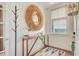 Stylish entryway with a round mirror, wooden console table, and coat rack at 11 Francis St, Charleston, SC 29403