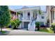 Charming two-story home featuring a welcoming front porch, landscaped yard, and garage access at 11 Francis St, Charleston, SC 29403