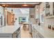 Bright kitchen with white cabinets, marble countertops, stainless steel appliances, and open flow to dining area at 11 Francis St, Charleston, SC 29403
