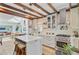 Open kitchen featuring an island with seating, stainless steel appliances, and seamless flow to dining area at 11 Francis St, Charleston, SC 29403