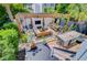 Inviting outdoor patio area with a fireplace, pergola, dining table, and bar for entertaining in this cozy backyard at 11 Francis St, Charleston, SC 29403
