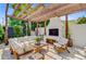 Cozy outdoor patio with fireplace, comfortable seating, and lush landscaping create an inviting space for relaxation and enjoyment at 11 Francis St, Charleston, SC 29403