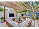 Outdoor patio with a fireplace, comfortable seating, a dining table and beautiful pergola, perfect for relaxing or entertaining at 11 Francis St, Charleston, SC 29403