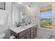 Bright bathroom featuring double sinks, quartz countertop, and a large mirror at 112 Crimson St, Summerville, SC 29486