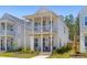 Charming two-story home with double porches, light siding, rocking chairs, and manicured landscaping at 112 Crimson St, Summerville, SC 29486