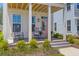 Inviting front porch with rocking chairs and a pink door, creating a cozy curb appeal at 112 Crimson St, Summerville, SC 29486