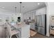 Open-concept kitchen featuring a large island, stainless steel appliances, and views into the living area at 112 Crimson St, Summerville, SC 29486