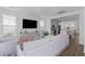 Bright living room featuring a large comfortable couch with kitchen and dining area in the background at 112 Crimson St, Summerville, SC 29486