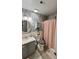 Cozy bathroom with wood-look accent wall, shower and vanity at 114 Sea Cotton Cir, Charleston, SC 29412