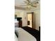 Bedroom with wooden sliding door leading to the bathroom; a comfortable bed dressed in neutral tones at 114 Sea Cotton Cir, Charleston, SC 29412