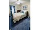 Comfortable bedroom features a ceiling fan, blue carpet, and large window at 114 Sea Cotton Cir, Charleston, SC 29412