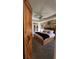 Bedroom featuring a wooden sliding door; a comfortable bed dressed in neutral tones and a wood accent wall at 114 Sea Cotton Cir, Charleston, SC 29412