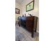 A wooden buffet table sits on tile flooring, complemented by stylish wall decor, creating a welcoming dining area at 114 Sea Cotton Cir, Charleston, SC 29412