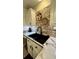 Modern kitchen sink featuring white cabinets, a stone backsplash, and a sleek black faucet at 114 Sea Cotton Cir, Charleston, SC 29412