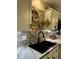 Modern kitchen sink with black faucet, stone backsplash, and white cabinets offers contemporary convenience at 114 Sea Cotton Cir, Charleston, SC 29412