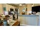 Bright kitchen features white cabinetry, stainless steel appliances, and an island with breakfast bar seating at 114 Sea Cotton Cir, Charleston, SC 29412