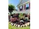 Lush landscaping, flowering plants, and decorative stones enhance the curb appeal at 114 Sea Cotton Cir, Charleston, SC 29412