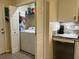 Bright laundry room with washer, dryer, storage shelves, and white cabinets offers convenience and functionality at 114 Sea Cotton Cir, Charleston, SC 29412