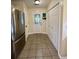 The mud room features a stainless steel refrigerator, tile flooring, and ample storage cabinets for organization at 114 Sea Cotton Cir, Charleston, SC 29412