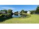 Scenic view of a community pond reflecting the surrounding homes and lush landscaping at 114 Sea Cotton Cir, Charleston, SC 29412