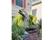 Whimsical dolphin statue with sunglasses adds charm to the landscaped yard at 114 Sea Cotton Cir, Charleston, SC 29412