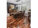 Elegant dining room featuring wood floors, a modern light fixture, and textured accent wall at 1195 Village Creek Ln # 2, Mount Pleasant, SC 29464
