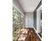 Hallway showcasing wood floors, textured wall, a white door, and a large sliding glass door that allows for ample natural light at 1195 Village Creek Ln # 2, Mount Pleasant, SC 29464