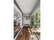 Bright hallway featuring wood floors, a bench, a textured accent wall, and a large sliding glass door for natural light at 1195 Village Creek Ln # 2, Mount Pleasant, SC 29464