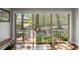 Bright hallway with a large sliding glass door overlooking a patio with a bench and lush greenery at 1195 Village Creek Ln # 2, Mount Pleasant, SC 29464