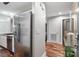 Hallway showcasing hardwood floors, stainless steel refrigerator and modern fixtures, creating a welcoming atmosphere at 1195 Village Creek Ln # 2, Mount Pleasant, SC 29464