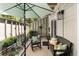 Cozy patio space with shaded seating, plantings and an umbrella at 1195 Village Creek Ln # 2, Mount Pleasant, SC 29464