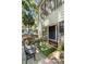 Exterior view of a patio featuring a decorative bench with colorful pillows, greenery, and a sliding glass door at 1195 Village Creek Ln # 2, Mount Pleasant, SC 29464