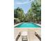 Community pool surrounded by lush trees and lounge chairs at 1195 Village Creek Ln # 2, Mount Pleasant, SC 29464