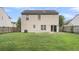 Spacious fenced backyard featuring a lush green lawn and a sliding glass door to the house at 125 Towering Pine Dr, Ladson, SC 29456