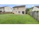 Spacious backyard with a grassy area, patio and privacy fence, perfect for outdoor enjoyment at 125 Towering Pine Dr, Ladson, SC 29456