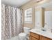 Well-lit bathroom with a shower, toilet, and a sink with a wood-finished vanity at 125 Towering Pine Dr, Ladson, SC 29456