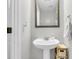 Cozy powder room featuring a pedestal sink, framed mirror, and neutral wall color at 125 Towering Pine Dr, Ladson, SC 29456