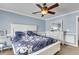 Bedroom featuring a large window, a ceiling fan, and a calm blue painted wall creating relaxation at 125 Towering Pine Dr, Ladson, SC 29456