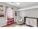 Charming Bedroom with a pink bookcase, gray glider, and comfortable baby furniture at 125 Towering Pine Dr, Ladson, SC 29456