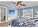 Bedroom featuring a large window, blue painted wall, television, ceiling fan for modern and relaxing atmosphere at 125 Towering Pine Dr, Ladson, SC 29456