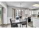 Dining area featuring a wooden table set, neutral decor, and view of the kitchen at 125 Towering Pine Dr, Ladson, SC 29456