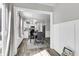 Bright dining area with modern table, leading to a well-equipped kitchen and natural light at 125 Towering Pine Dr, Ladson, SC 29456