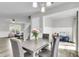 Open dining area with a wooden table and view of the living room and playroom at 125 Towering Pine Dr, Ladson, SC 29456