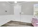 Inviting entryway featuring white wainscoting, a secure keypad lock, and wood-look flooring at 125 Towering Pine Dr, Ladson, SC 29456