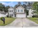 Charming two-story home with blue shutters, well-maintained lawn, and large driveway at 125 Towering Pine Dr, Ladson, SC 29456